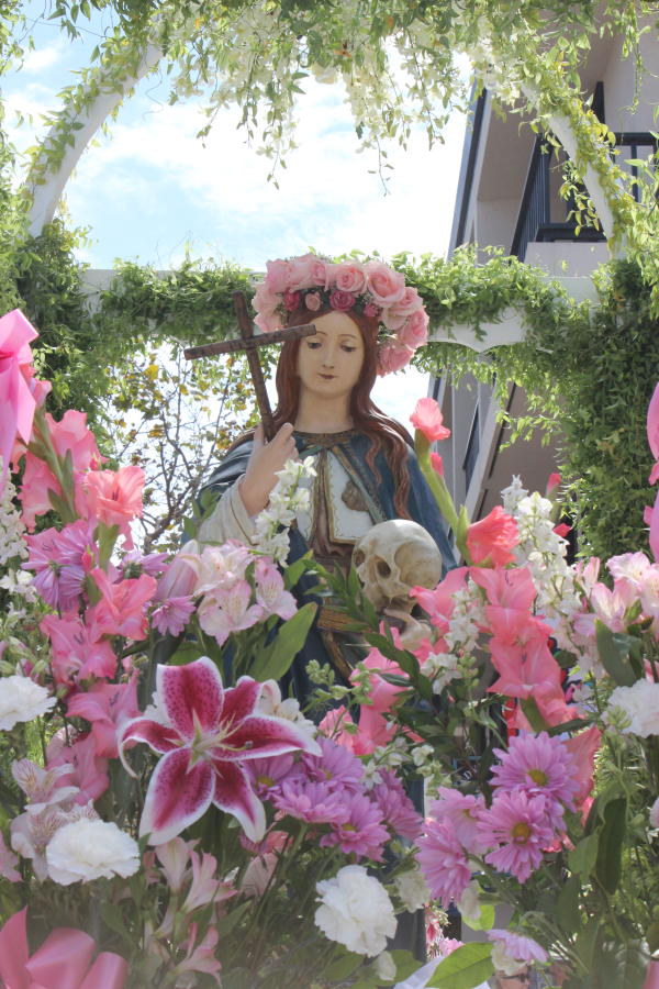 Flowers Surrounding a Statue of Mary At Festa Italia