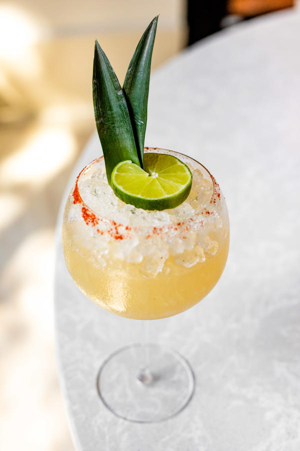 Rocks glass with margarita drink and a lime wedge garnish at Mahesh's Kitchen restaurant