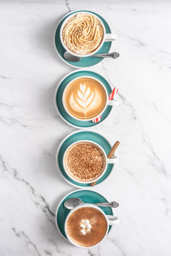 Four lattes align vertically down the image: gingerbread, peppermint, tiramisu, and pumpkin spice.