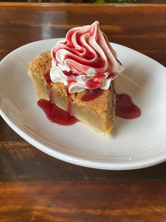 A slice of pie with whipped cream on top