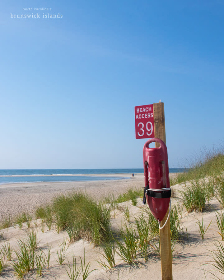 a beach access sign and flotation device on Bald Head Island, NC