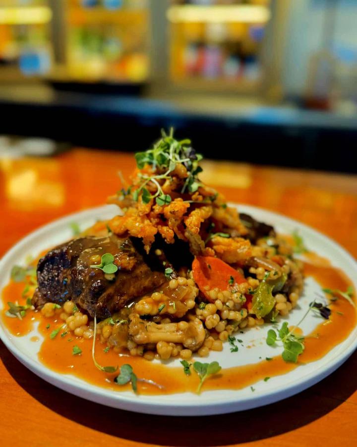 couscous topped with steak and assorted veggies served at Fish Factory Restaurant and Bar in Southport