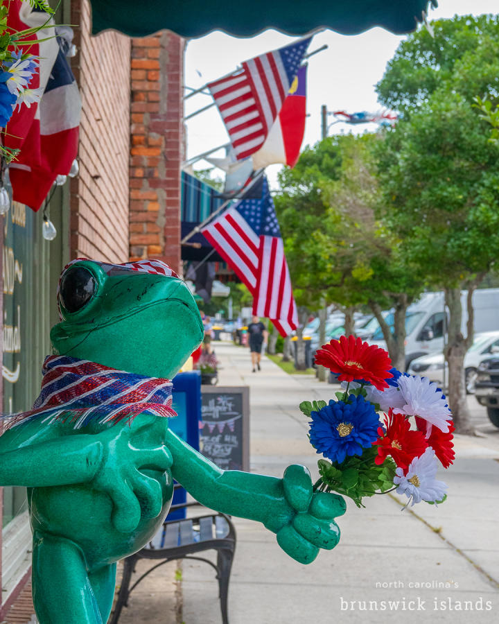 a frog statue outside of a store in Southport, NC during the NC 4th of July Festival