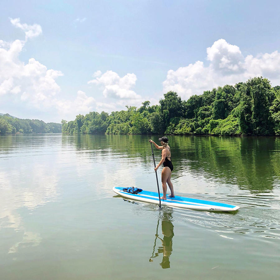 A lone visitor glides along the Huntsville waterways on a stand-up paddleboard.
