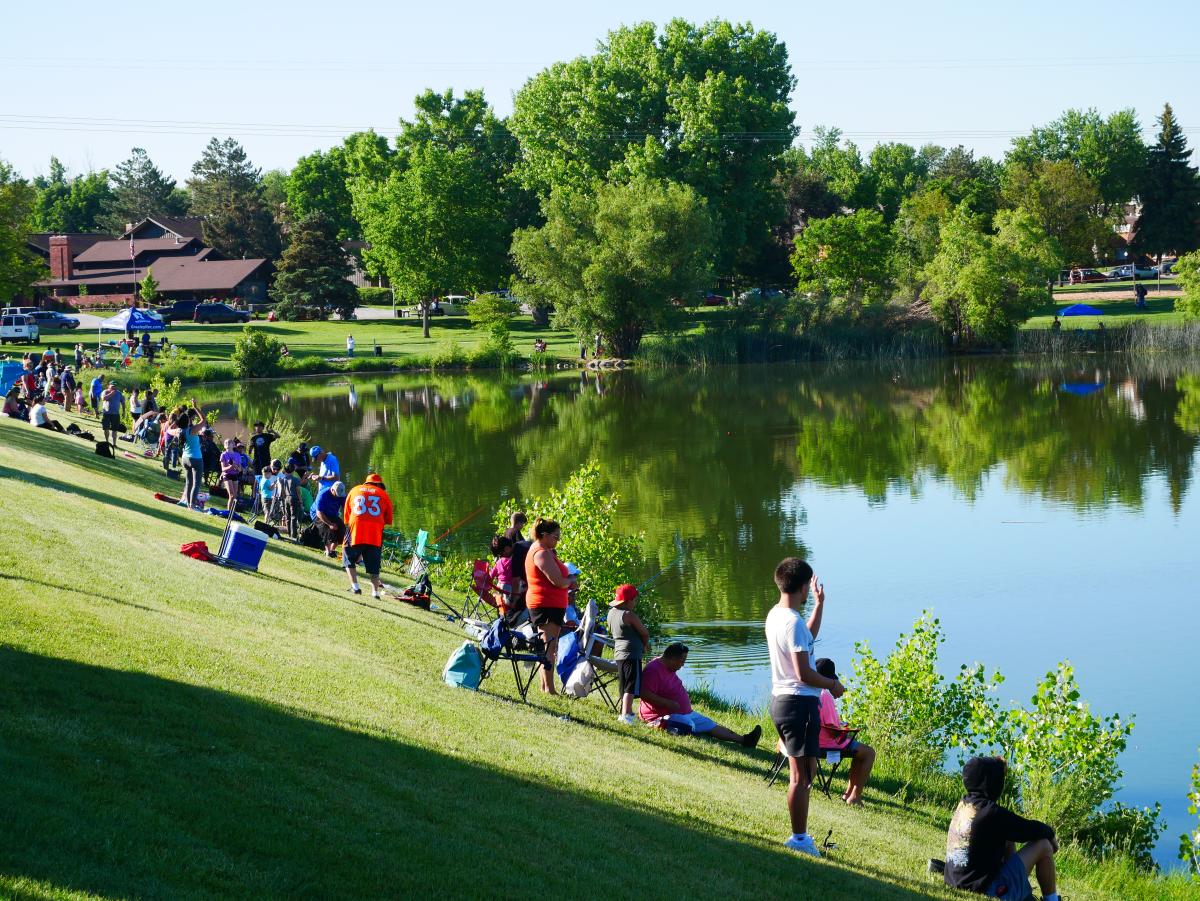 Multiple people fishing at pond in Greeley, CO
