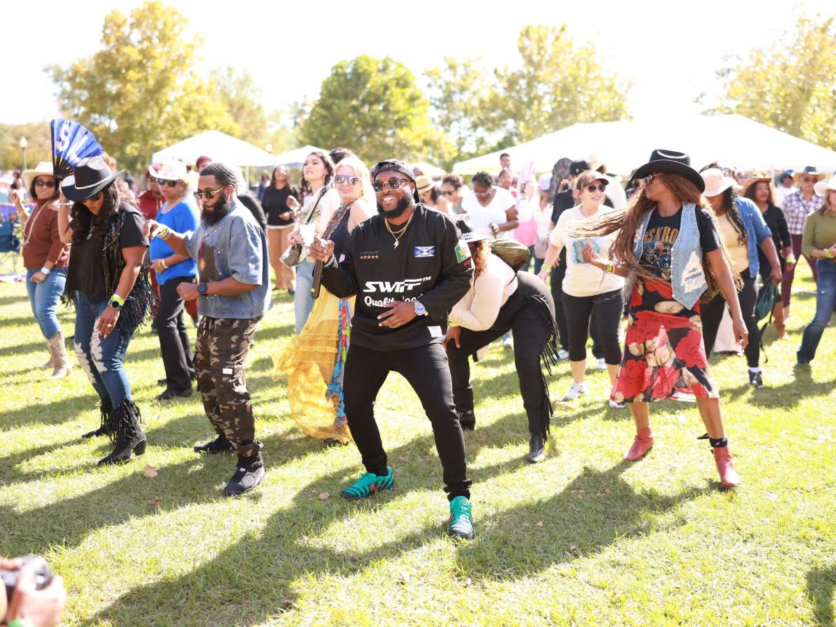 Festivalgoers dance together on the lawn during NOLA Zydeco Fest at Heritage Park in Slidell.