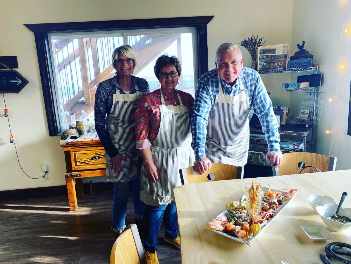 Three people with their charcuterie board finished and ready to eat!