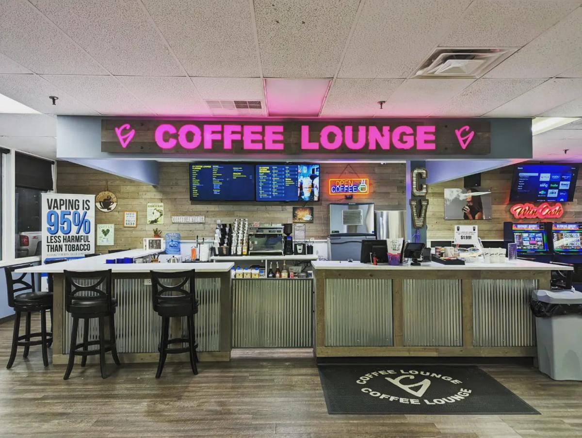 Image of inside the coffee shop's front counter with the words "CV Coffee Lounge" in big, pink letters above the counter.