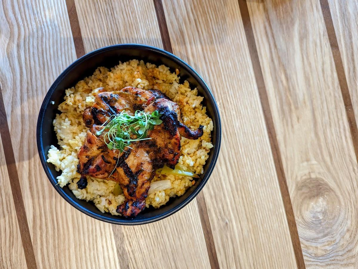 Image is of Amadors Pollo Asado which is a grilled, flavorful chicken breast over a bead of yellow rice.