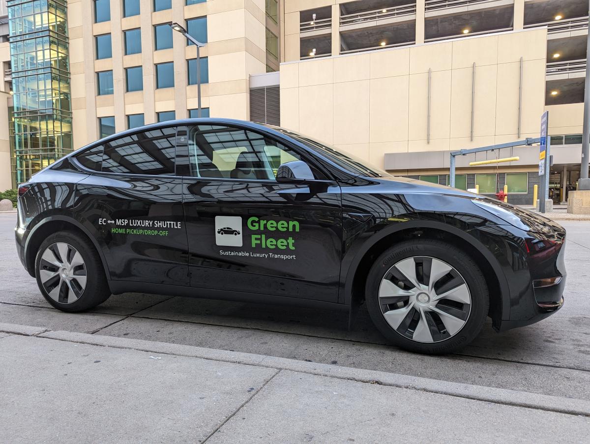 A black Tesla - Green Fleet transportation service