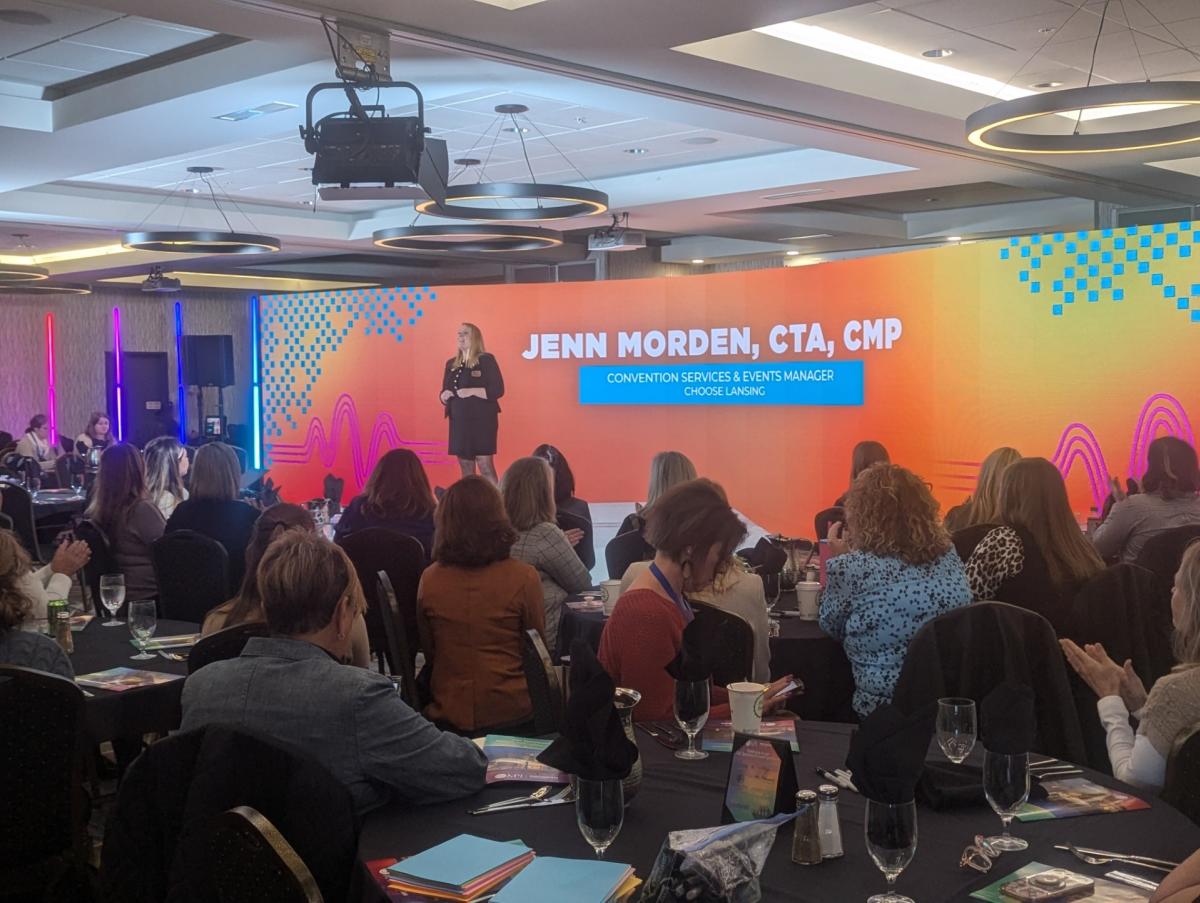 Speaker on stage in front of attendees