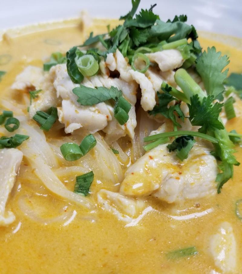 a close-up of a bowl of curry noodle soup from Thai Boran
