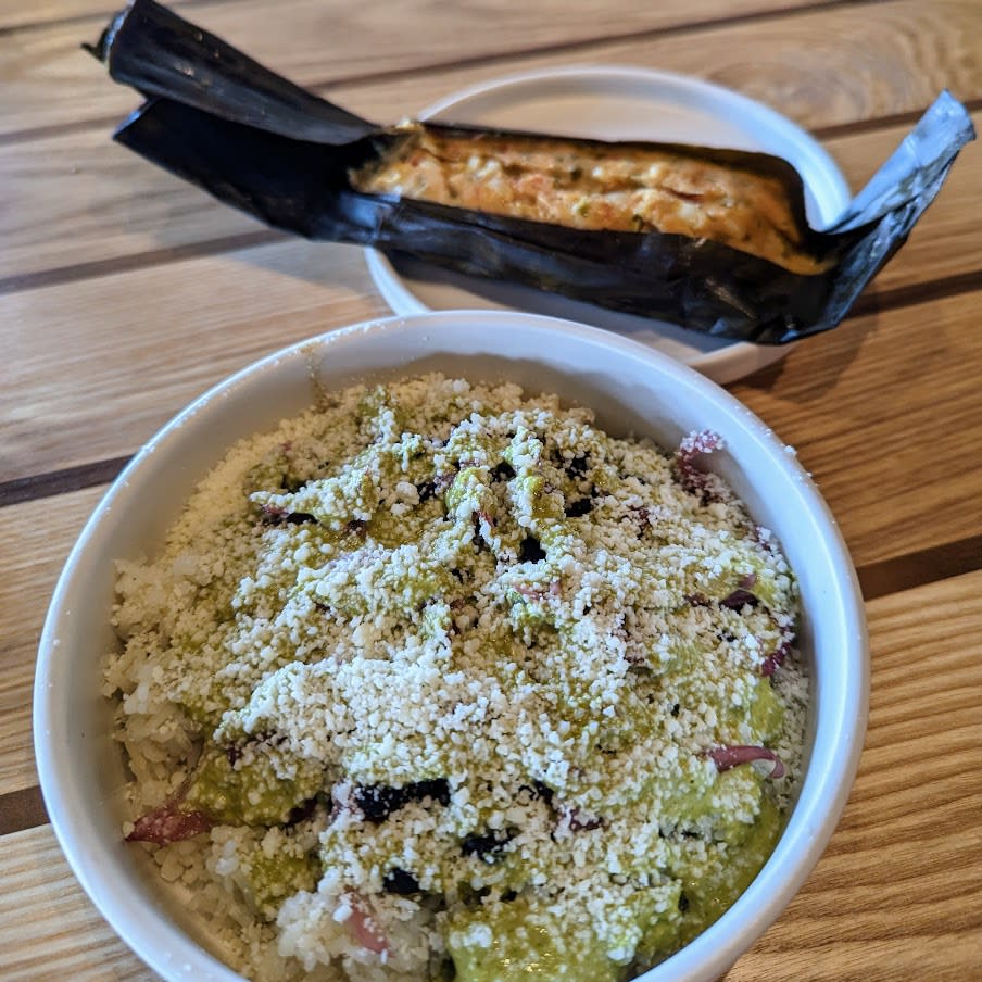 Image is of Amador's Tamal which is a savory tamale with a bowl of veggies and rice.