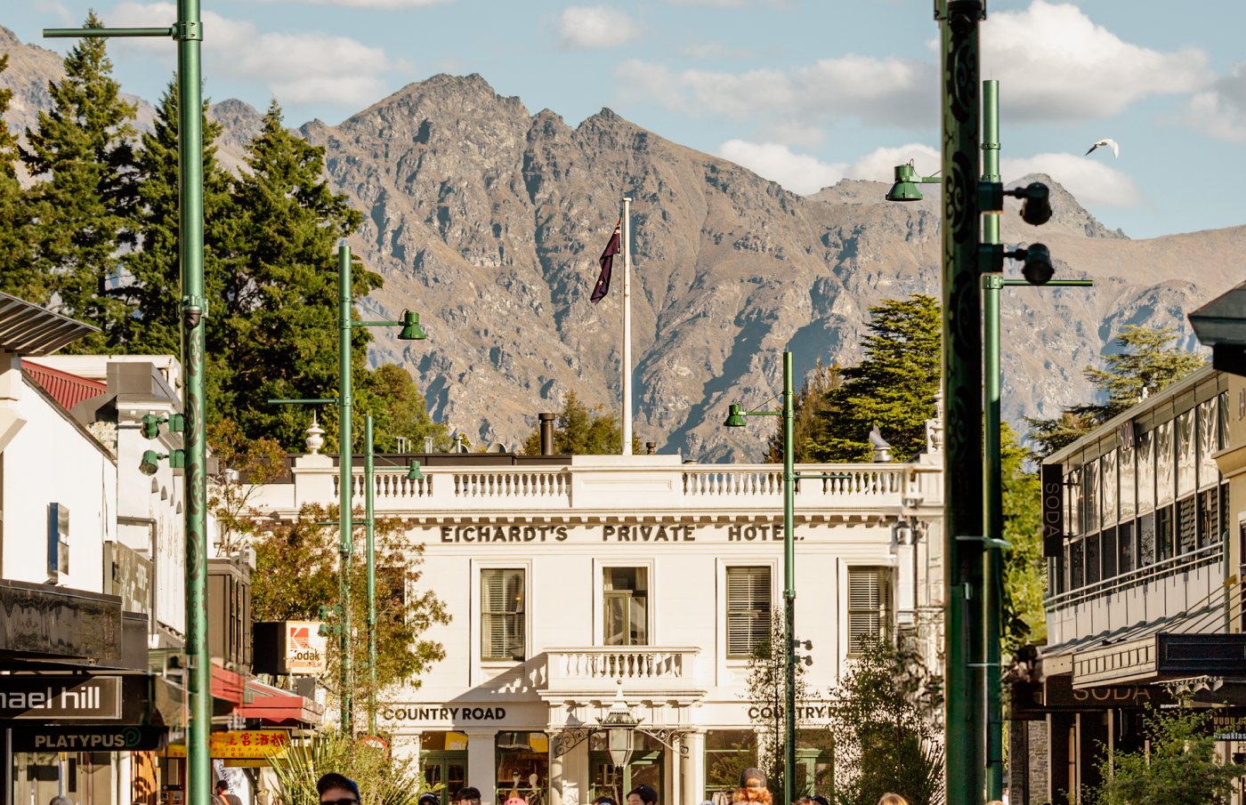 Exterior of Eichardt's Private Hotel with mountains in the background