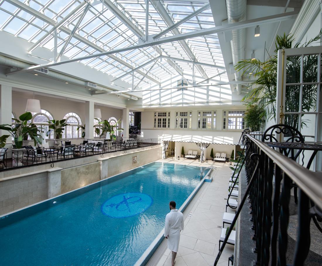 Person walking in indoor swimming pool