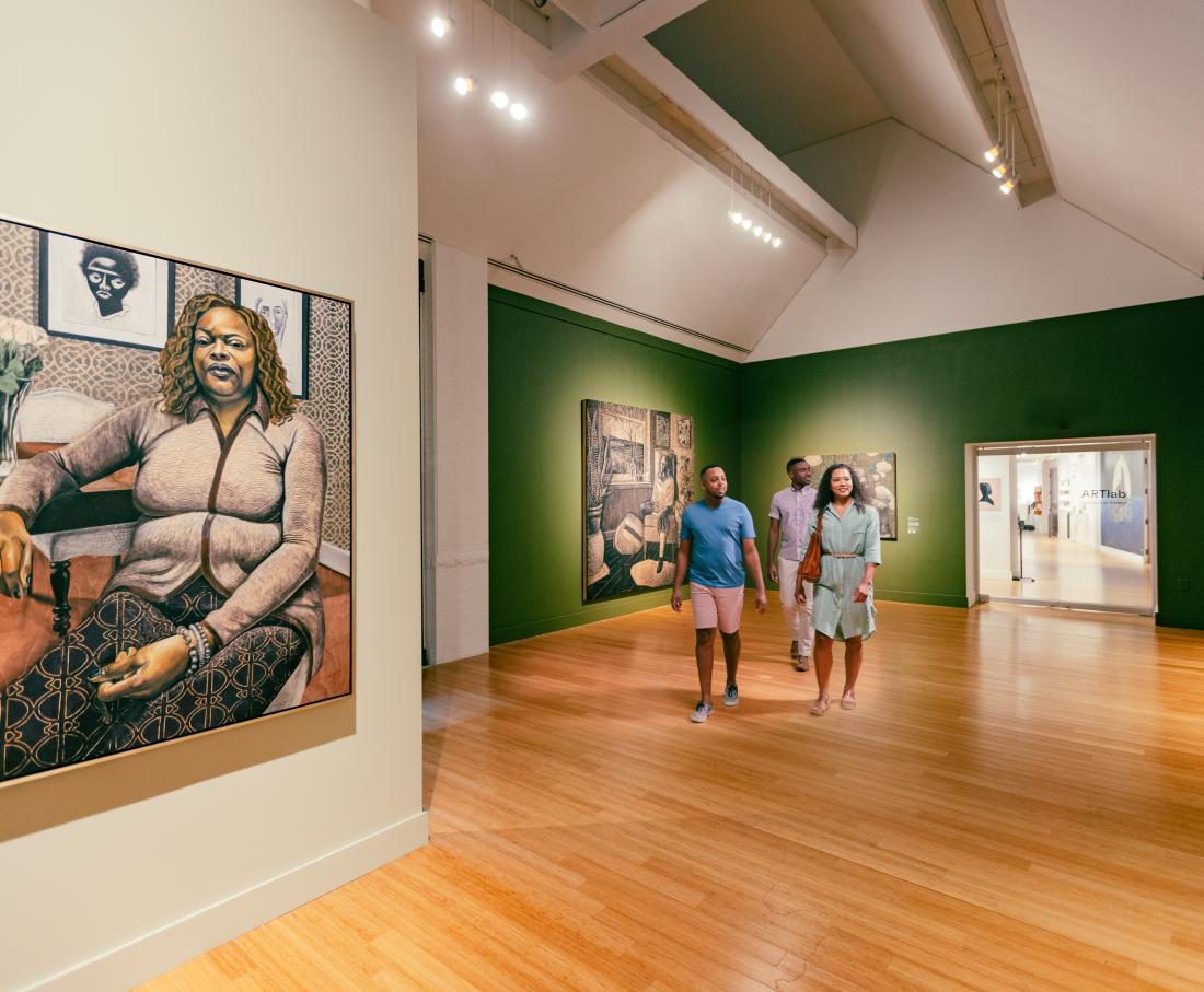 people walking through a museum