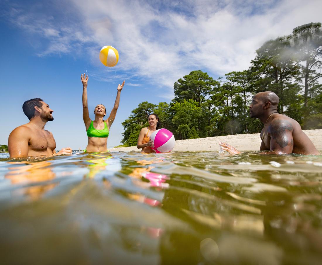 people swimming and playing in natural park