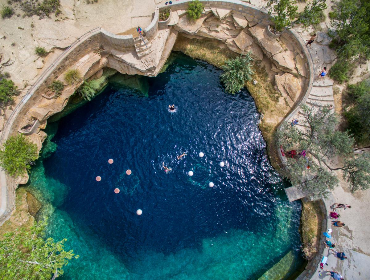 Arial shot of the blue hole, a deep natural sinkhole filled with clear blue water