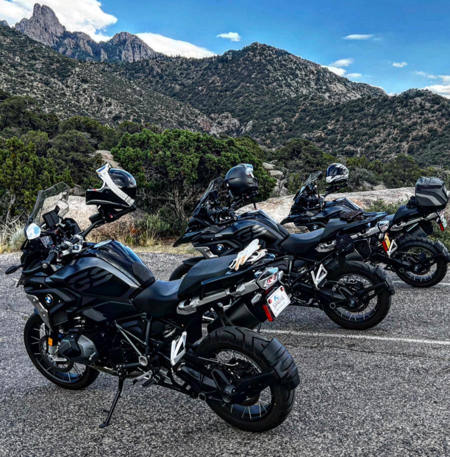 Motorcycles sit parked in a parking lot in the East Mountains