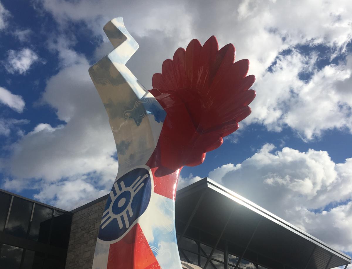 A statue of the Keeper of the Plains is painted with the Wichita flag design