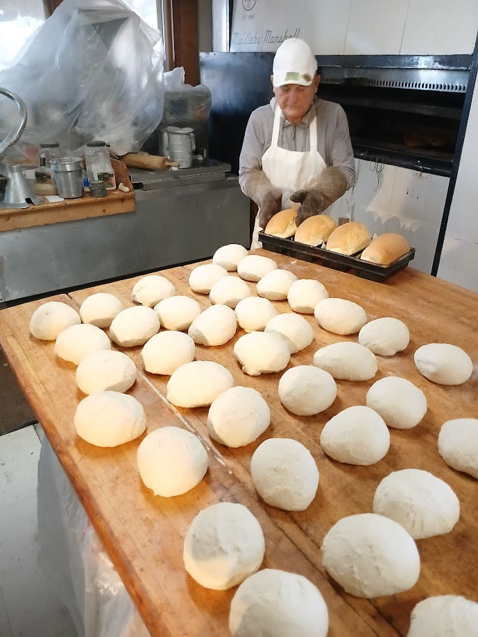 A man bakes bread at Golden Crown Panaderia to donate 1,000 loaves of bread to Roadrunner Food Bank.