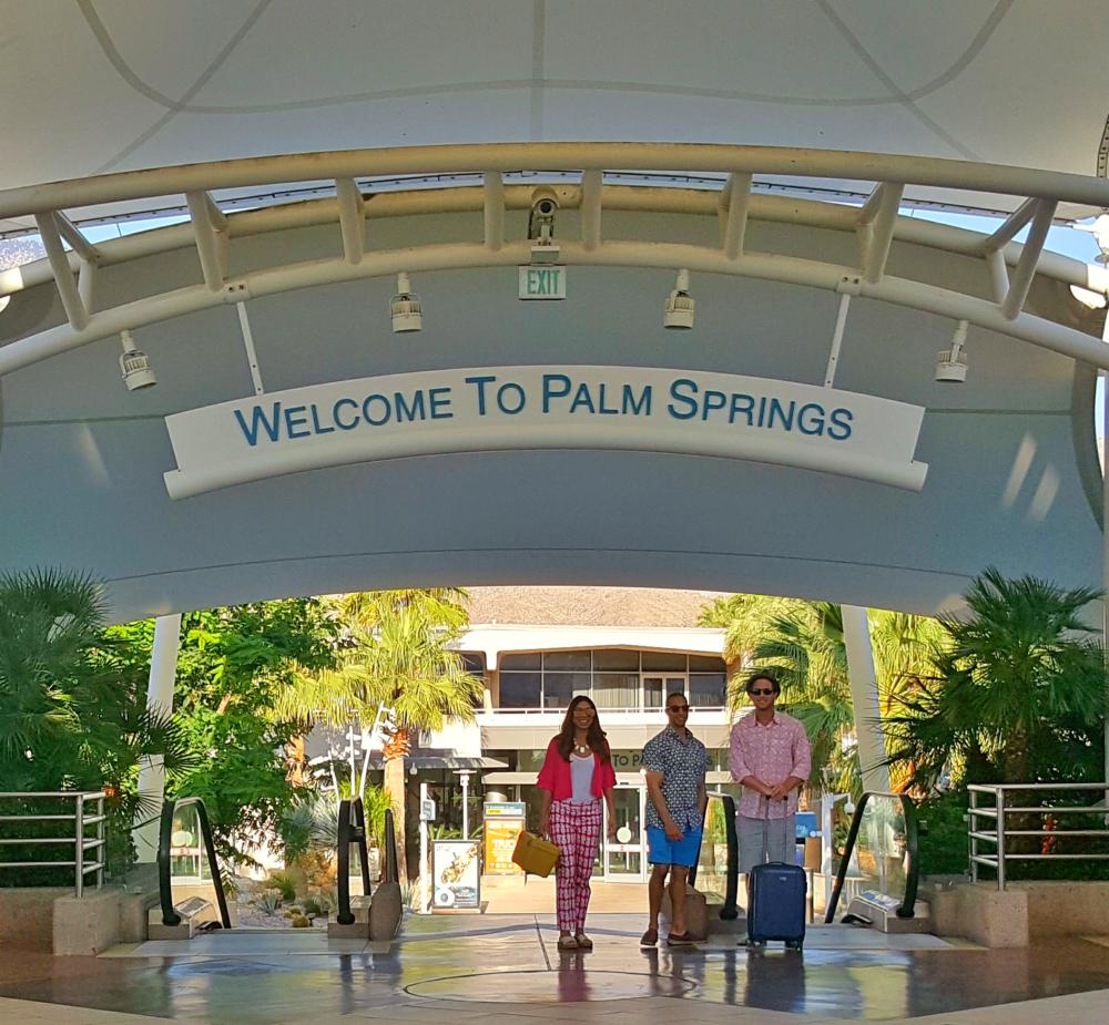 Three people walking to gate at PSP.