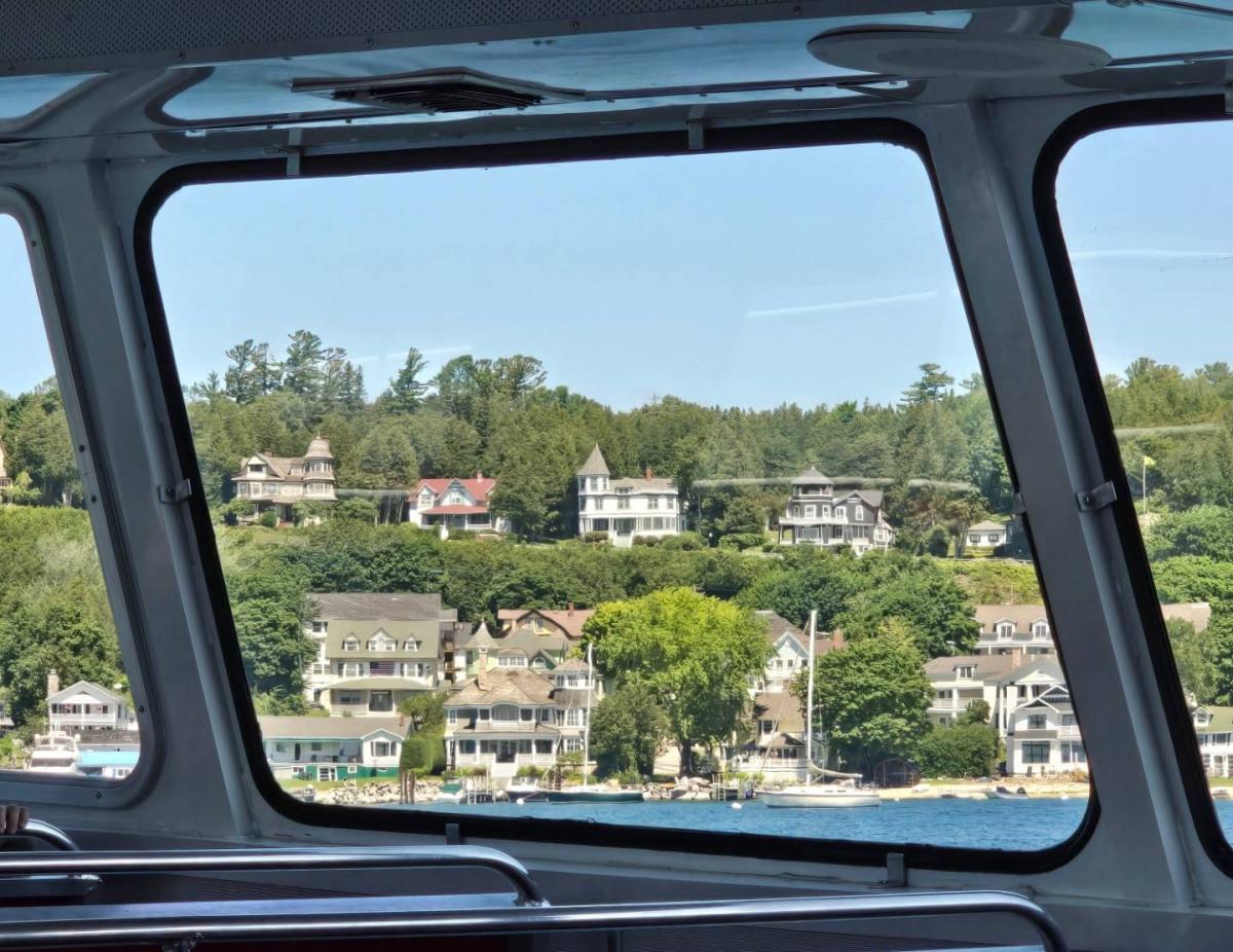 Mackinac Island cottages seen through the window of a ferry boat approaching the docks
