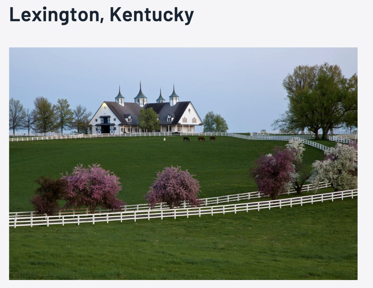 Landscape of a farm in the spring with white fencing.