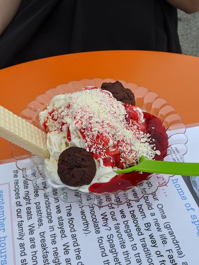 Vanilla ice cream shaped like spaghetti, strawberry syrup and brownies made to look like spaghetti and meatballs