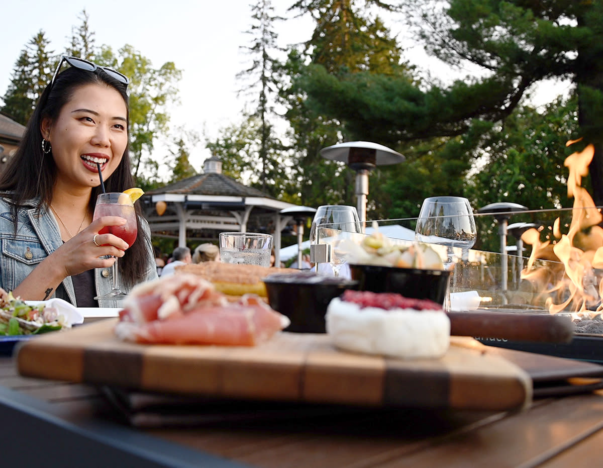 Woman enjoying her dinner outdoors at The Brewster Inn