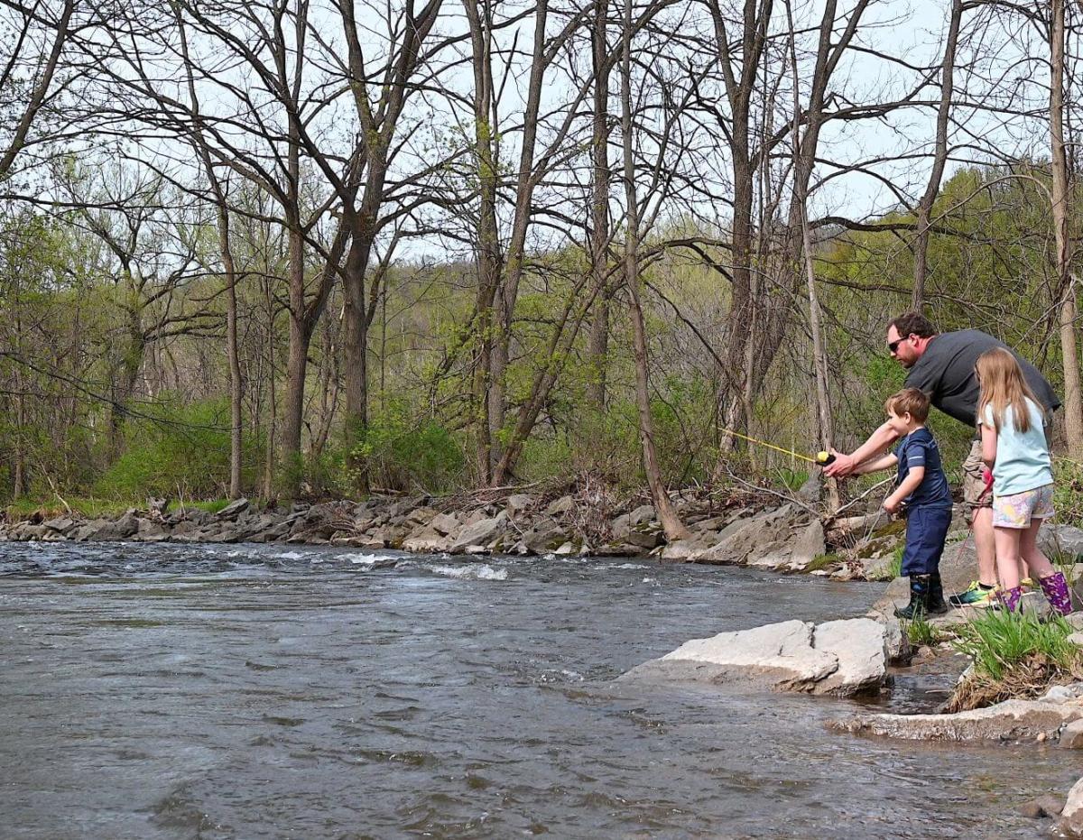 A family fishing at a creek in spring