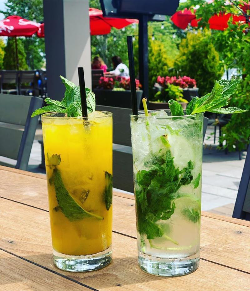 a pair of mojitos sit on an outdoor table at Malone's Bar & Grill