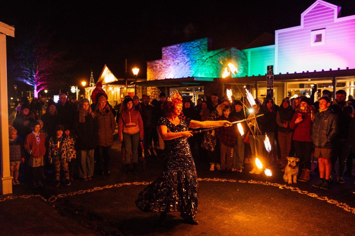 Fire dancer performs to crowd at night during Matariki Arrowtown Lights