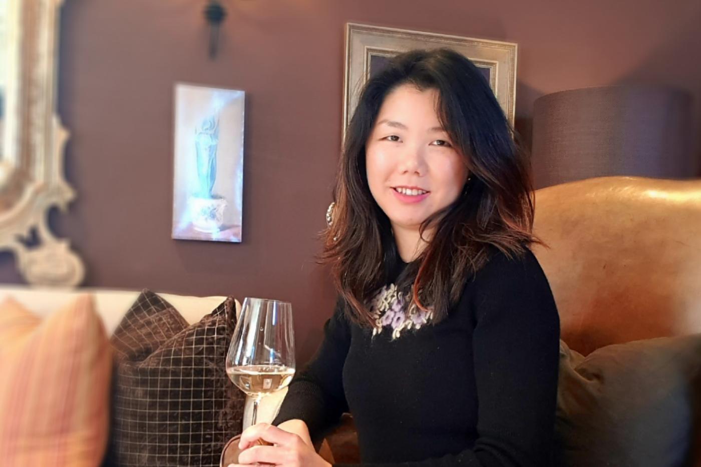 Wine reviewer and sommelier, Candice Chow, holding a glass of wine