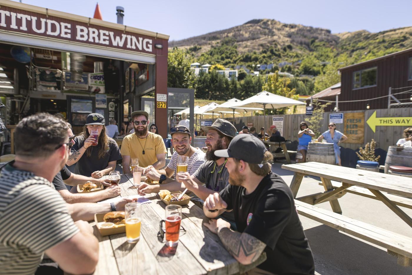 A group of people enjoying lunch and beers at Altitude Brewing