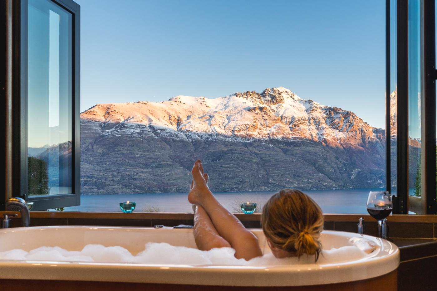 Woman relaxing in bath at Azur Lodge