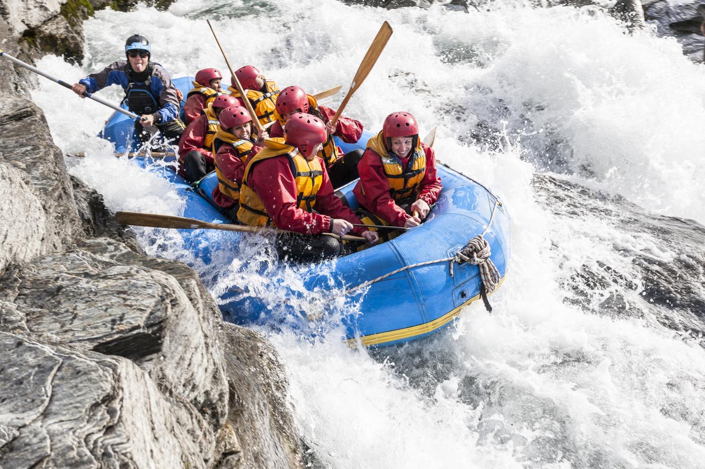 Rafting boat through white water rapids