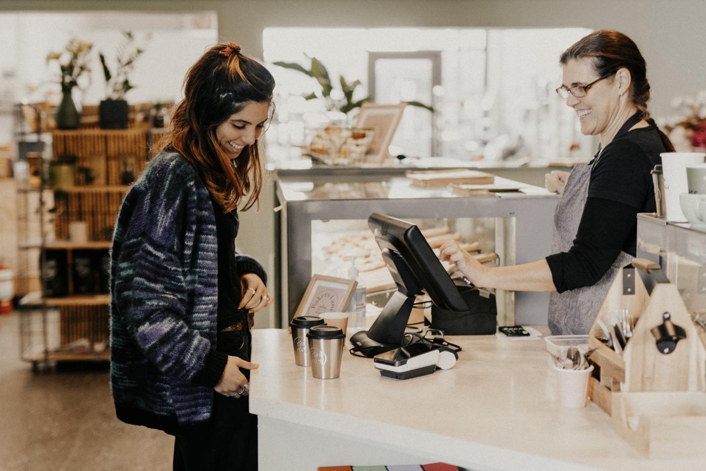 Person ordering coffee over the counter