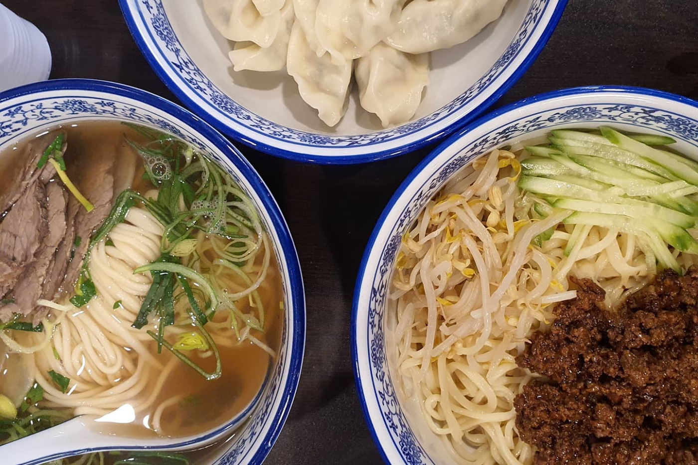 Two noodle dishes and dumplings