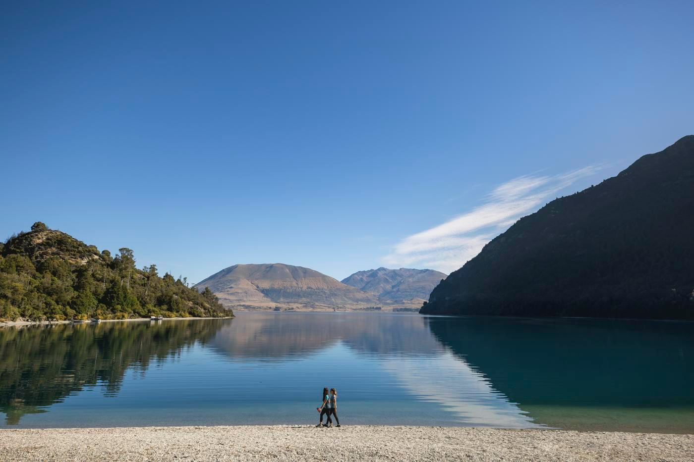 Lake with reflection of clear sky and mountains