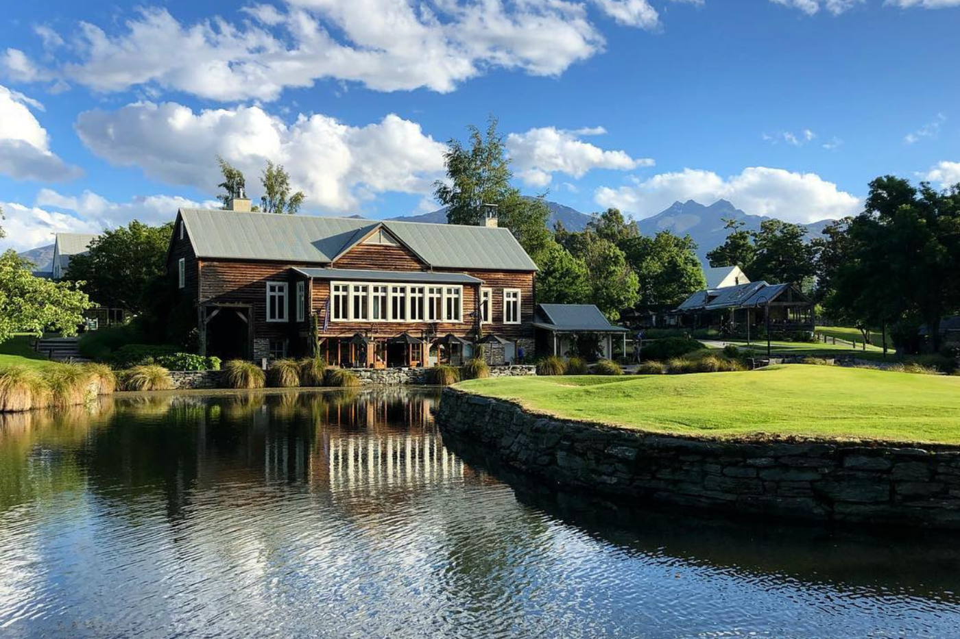 Rustic cabin surrounded by lake and gold course