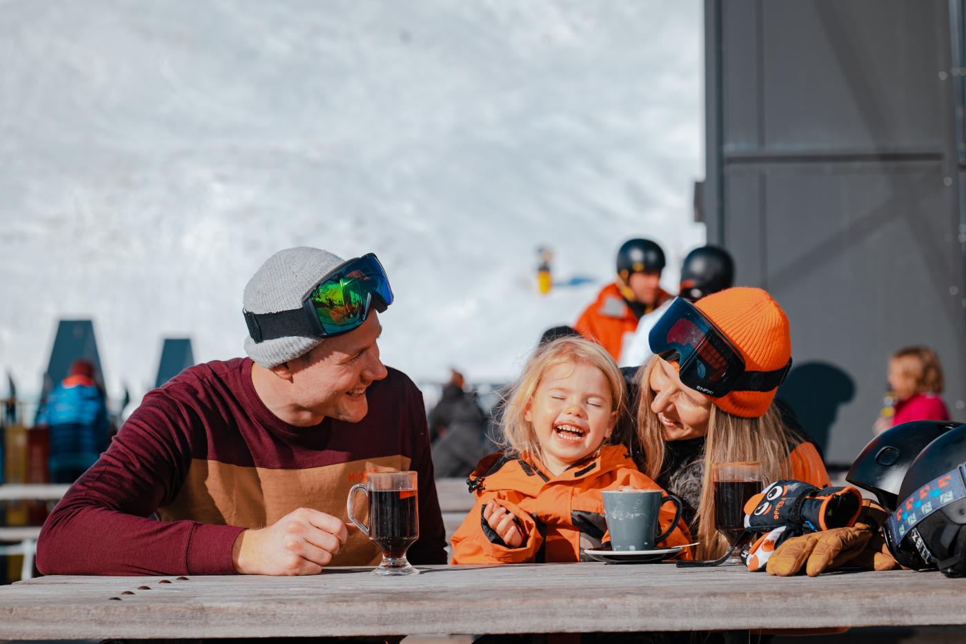 Family enjoying warm drinks at The Remarkables ski field