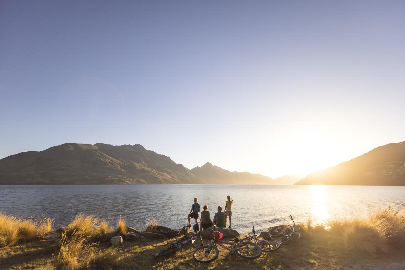 Family with bikes stop to admire views over Lake Whakatipu from Queenstown Gardens