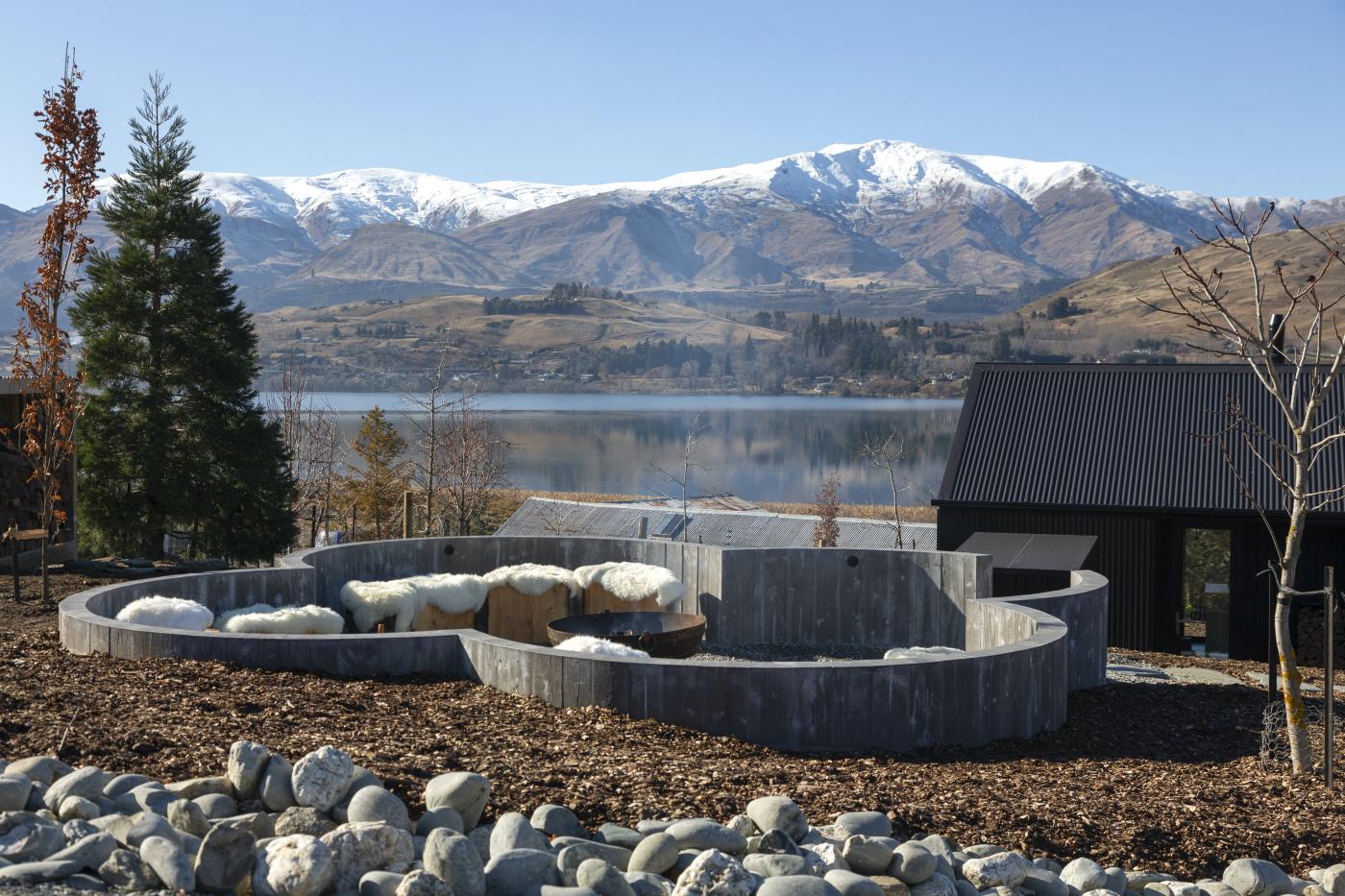 Fire pit overlooking snow-capped mountains at The Cottages at Lake Hayes, Accommodation
