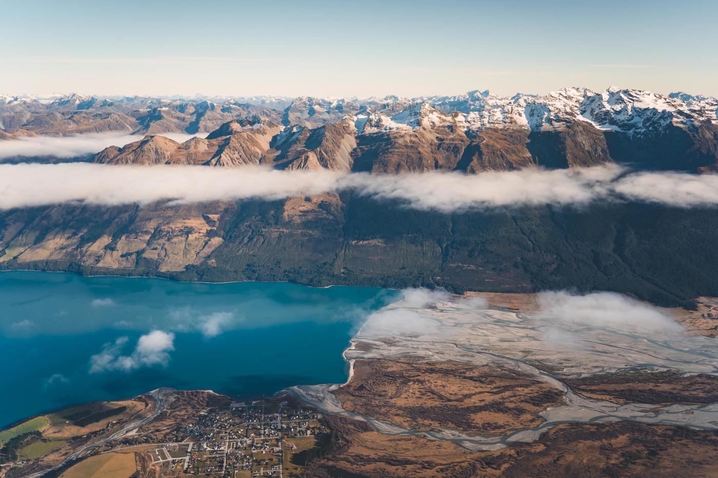 Aerial photo of Glenorchy township with huge mountains in the background