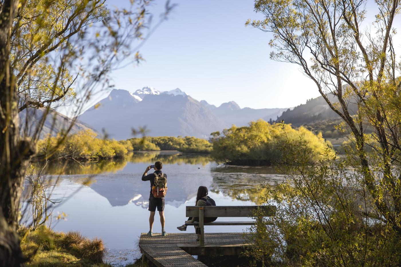 People enjoying the views of lake and mountains at the Glenorchy Lagoon Walkway