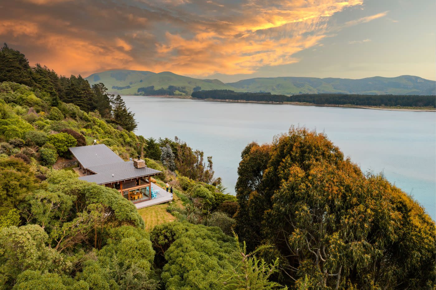 Kaimata Retreat building overlooking the Otago Peninsula at sunset