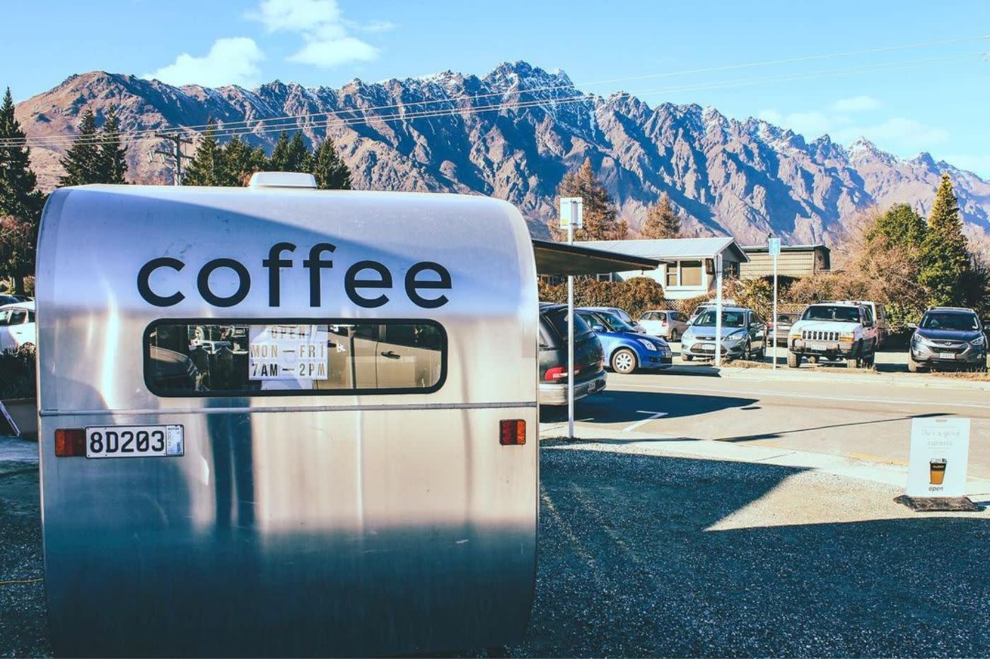 Silver Life's a Grind coffee van with mountain range behind