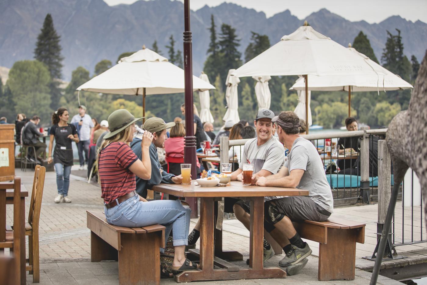 Group of friends enjoying Mountain Biking Apres outside at Atlas Bar