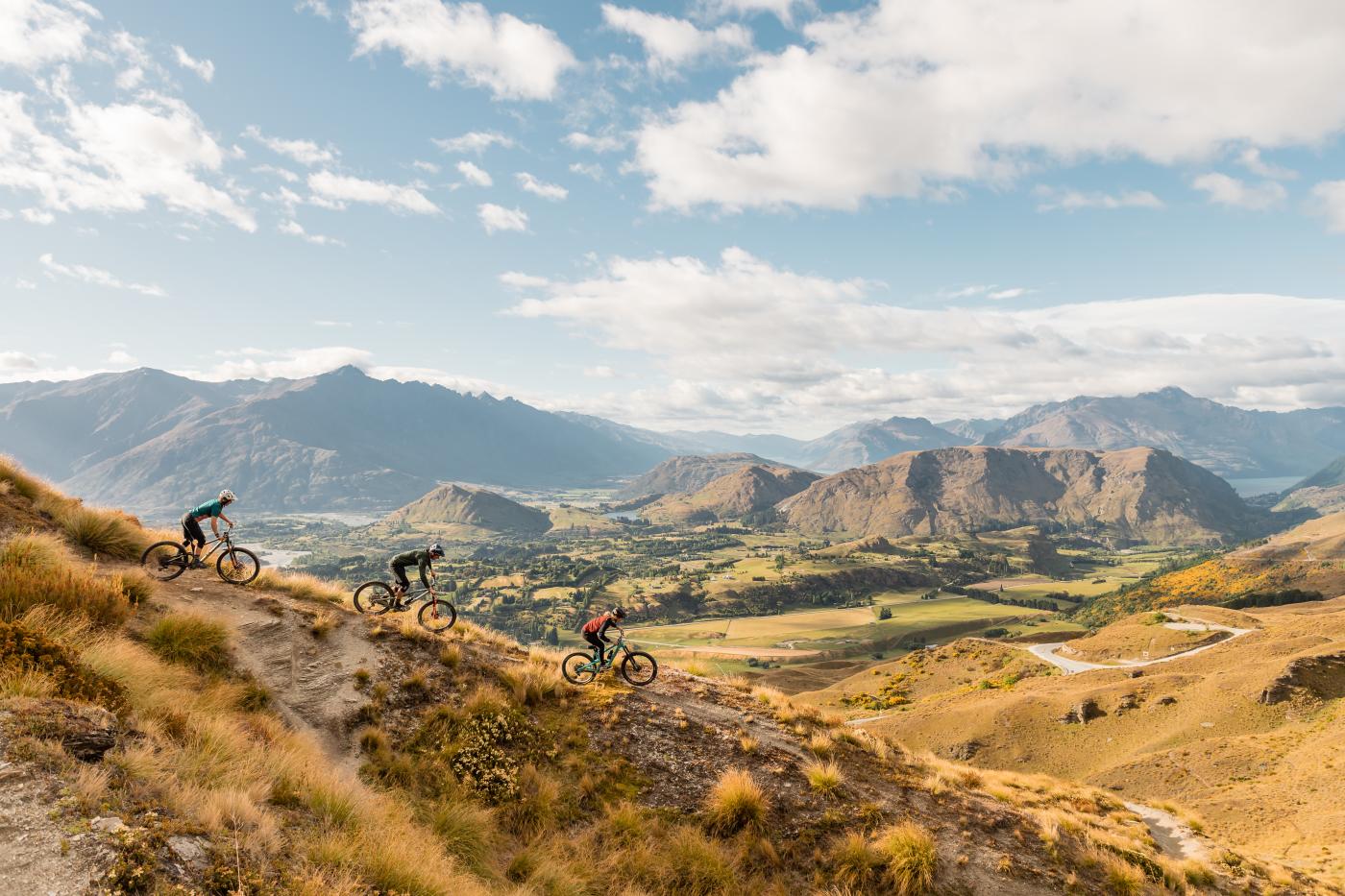 Three mountain bikers on Pack Sack and Track Trail, Coronet Peak